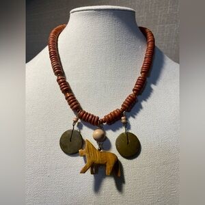 Wooden Beaded Necklace With. Wooden Animal and dangle Wooden Center Accents.